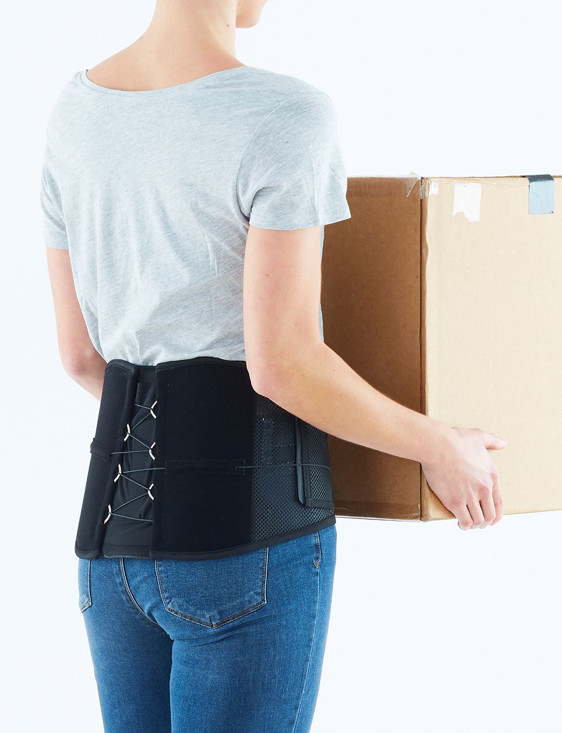 Woman wearing Neo G Adjusta-Fit Back Brace facing back holding a box