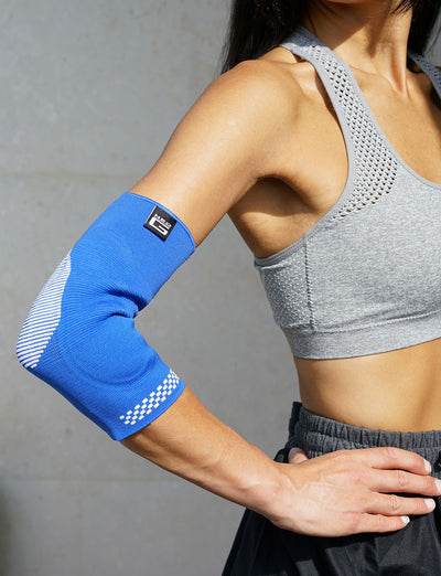 Woman wearing Neo G Airflow Plus Elbow Support with Silicone Joint Cushions on bent right arm 