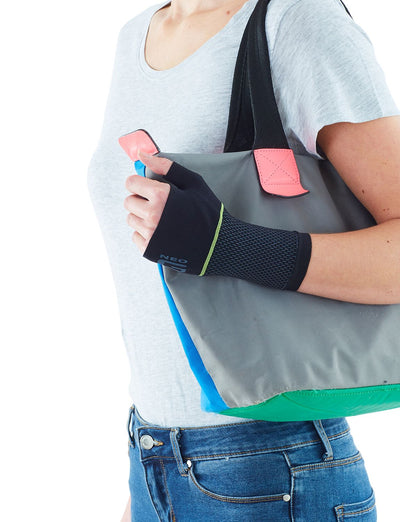 Woman wearing Neo G Active Wrist Support carrying a bag