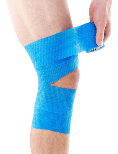 Man applying Blue Neo G NeoTape Cohesive Bandage around knee